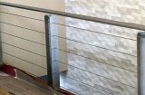 Custom railing constructed of steel with stainless wires. Complete fabrication including design, surface finishing and installation.