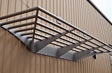 Custom tubular building canopy. Complete fabrication – design, laser cutting, forming, welding and painting.